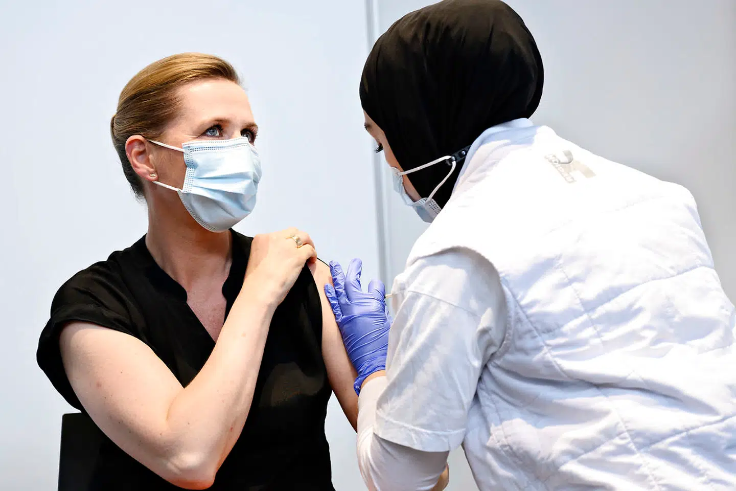 Statsminister Mette Frederiksen (S) bliver vaccineret imod covid-19 af vaccinatør Huda Beklar i Øksnehallen i København, fredag den 4. juni 2021.
