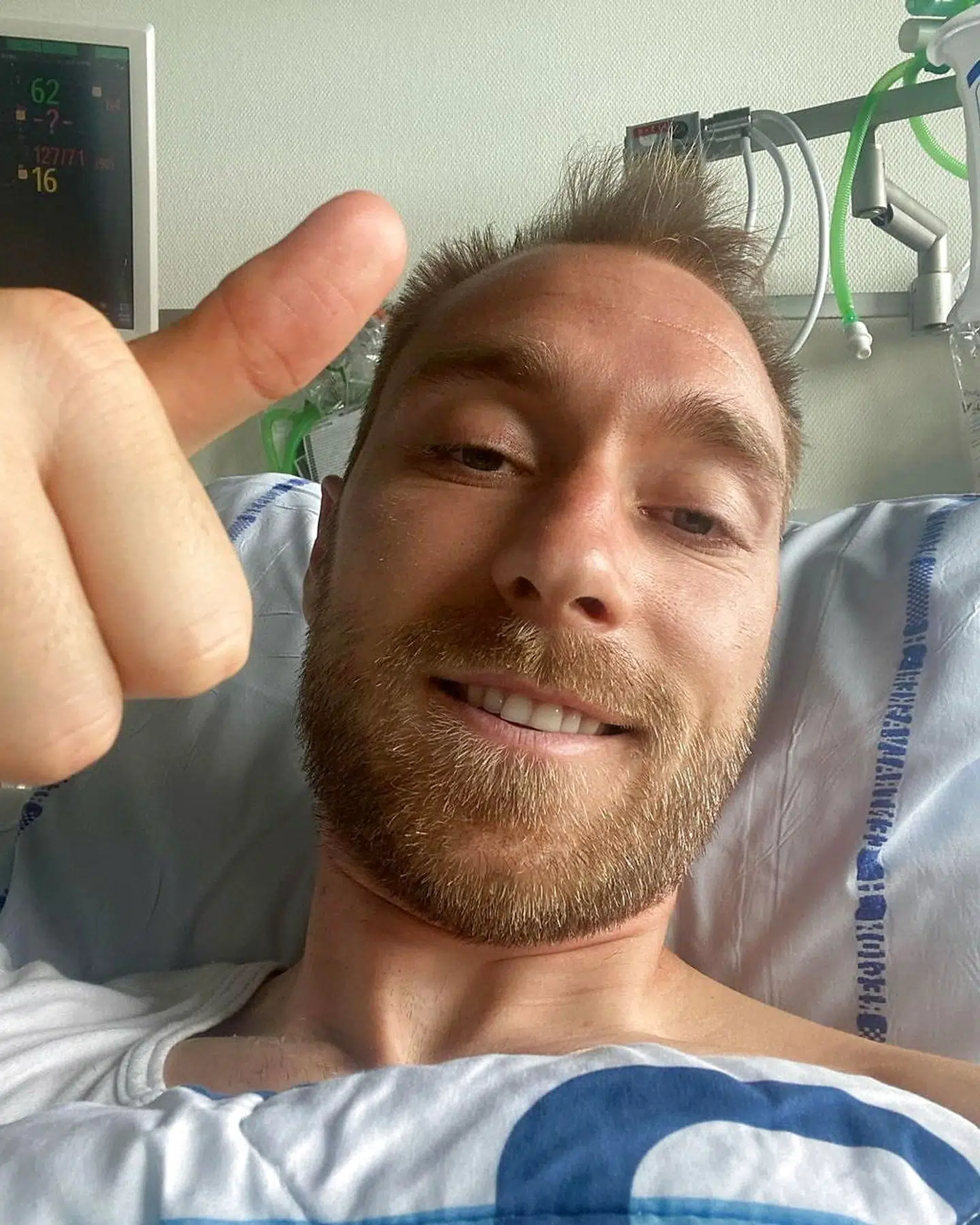 FILE PHOTO: Danish footballer Christian Eriksen gives a thumbs-up at Rigshospitalet, where he is treated after he collapsed during a UEFA Euro 2020 game on Saturday, in Copenhagen, Denmark, in this picture obtained from social media. Picture published June 15, 2021. Danish Football Association/via REUTERS THIS IMAGE HAS BEEN SUPPLIED BY A THIRD PARTY. MANDATORY CREDIT.NO RESALES.NO ARCHIVES./File Photo