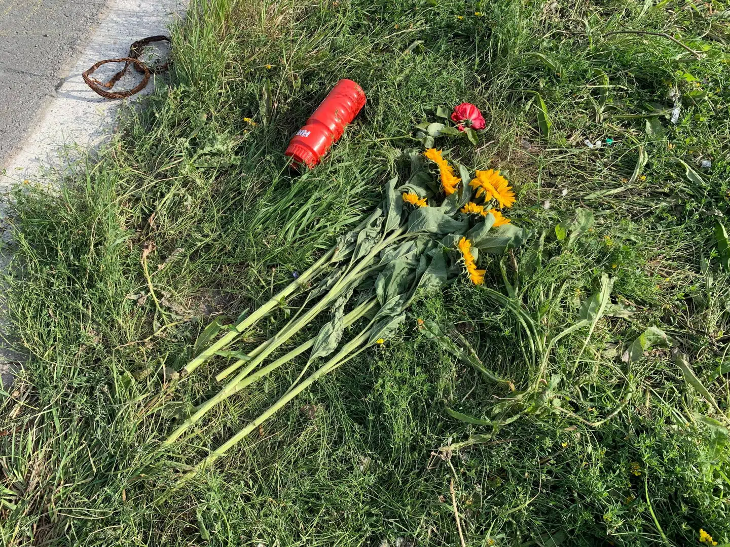 Der ligger en rød rose, en buket solsikker og en drikkedunk til ære for Chris Anker Sørensen.