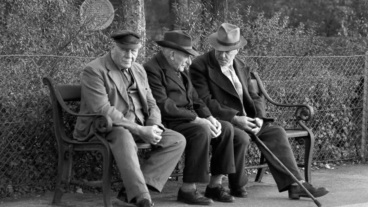Københavnerbænken blev designet tilbage i 1880erne og har tre grønne brædder og det svungne stel som kendetegn. Her ses et gammelt arkivfoto af tre ældre mænd på en københavnerbænk i De Gamles By på Nørrebro.