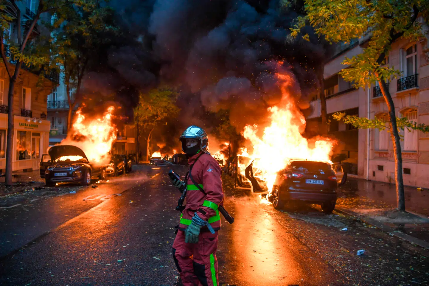 En brandmand betragter nogle af de mange brændende biler.