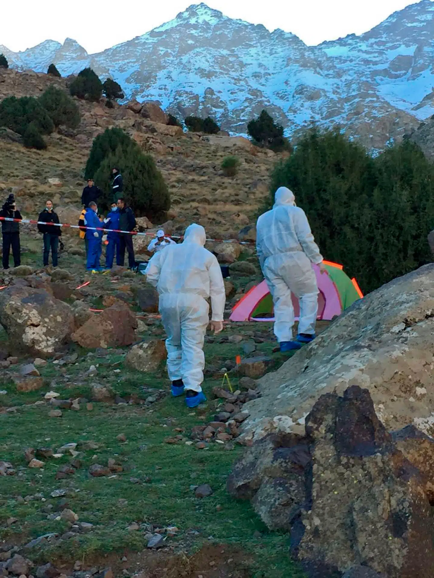 An image grab taken from a video broadcast in Morocco's news channel 2M on December 18, 2018 shows police officers next to a tent at the scene of a crime where the bodies of two Scandinavian women were found the day before in an isolated mountainous area 10 kilometres (six miles) from the tourist village of Imlil in the High Atlas range. - Moroccan authorities on December 18, 2018 arrested a suspect following the murder of a Danish and Norwegian hiker, who were found dead with cuts to their necks, the interior ministry said. Imlil is a starting point for trekking and climbing tours of Mount Toubkal, which at 4, 167 metres is the highest summit in North Africa. (Photo by - / various sources / AFP)