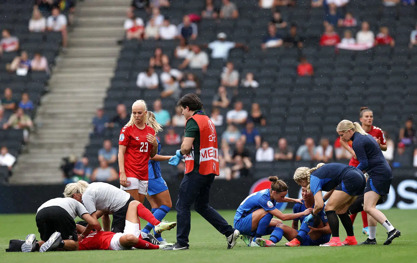 Soccer Football - Women's Euro 2022 - Group B - Denmark v Finland - Stadium MK, Milton Keynes, Britain - July 12, 2022 Denmark's Pernille Harder and Finland's Emma Koivisto react and receive medical attention after sustaining an injury REUTERS/Bernadett Szabo