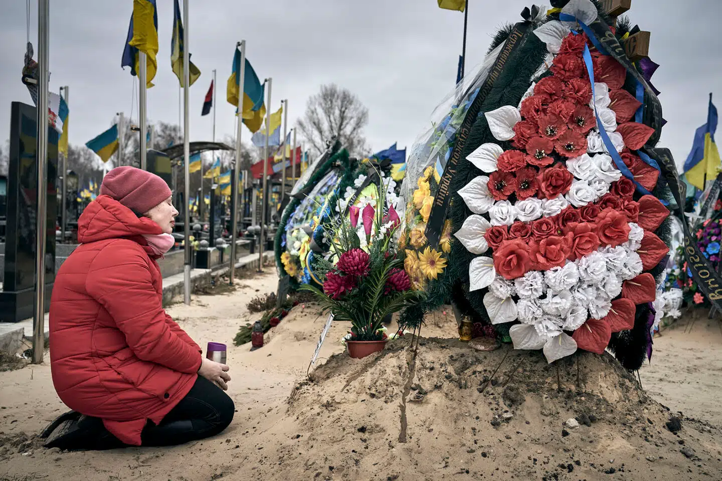 På Lisove-kirkegården i Kyiv sidder Olena og sørger over sin chef, der døde på Azovstal-værket i Mariupol. I dag ville det have været hans fødselsdag. Hendes egen mand blev fanget samme sted og har nu siddet ti måneder i fangenskab. Hun ved intet om ham ellers.