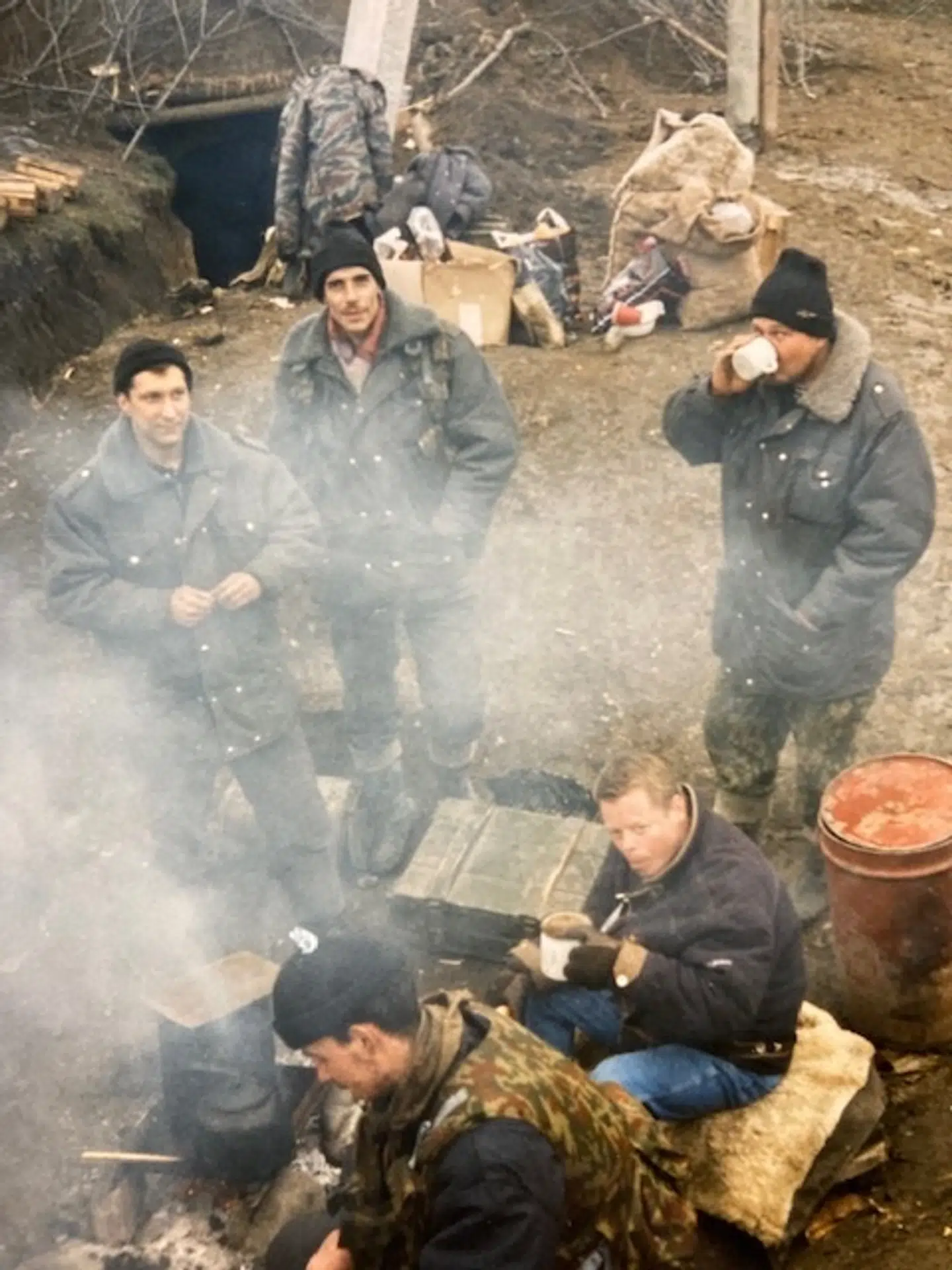 Carsten Haugaard (siddende forrest) i en russisk kampstilling, hvor han forhandler om frigivelse af cirka 4.000 civilpersoner, som er taget som gidsler i en belejret by.