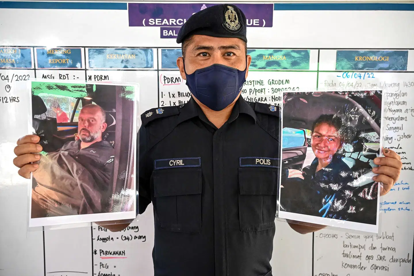 Politichef Cyril Edward i byen Mersing i Malaysia viser fotos af to dykkere - en fransk kvinde og en britisk mand, som forsvandt på havet under dykning ud for Malaysias kyst. De blev lørdag fundet i god behold efter to og et halvt døgn, hvor de drev over 100 kilometer væk fra det sted, hvor de forsvandt. Mohd Rasfan/Ritzau Scanpix