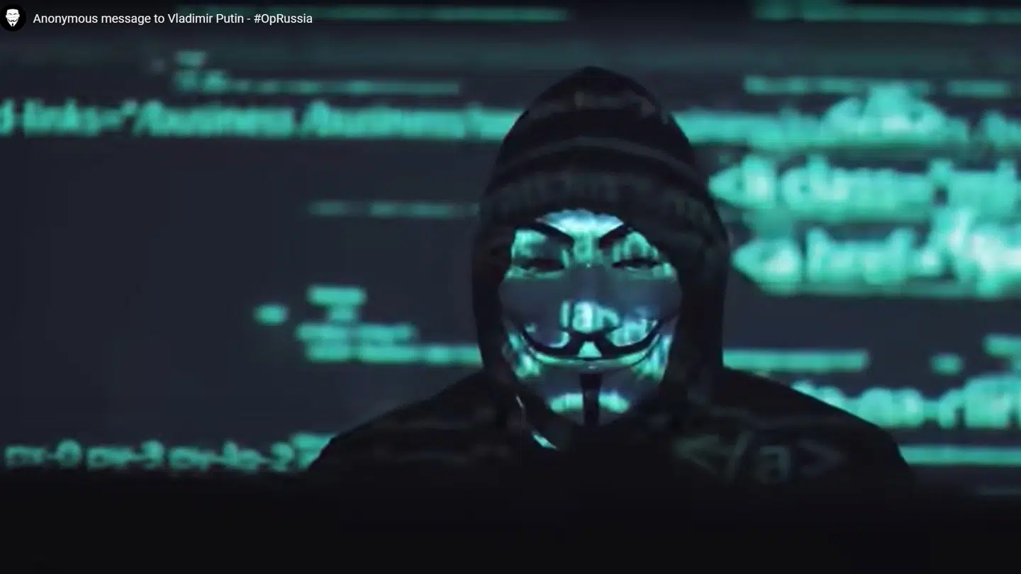 En person iklædt den velkendte Guy Fawkes-maske, som Anonymous er kendt for, med en besked til Vladimir Putin på Anonymous' vegne.