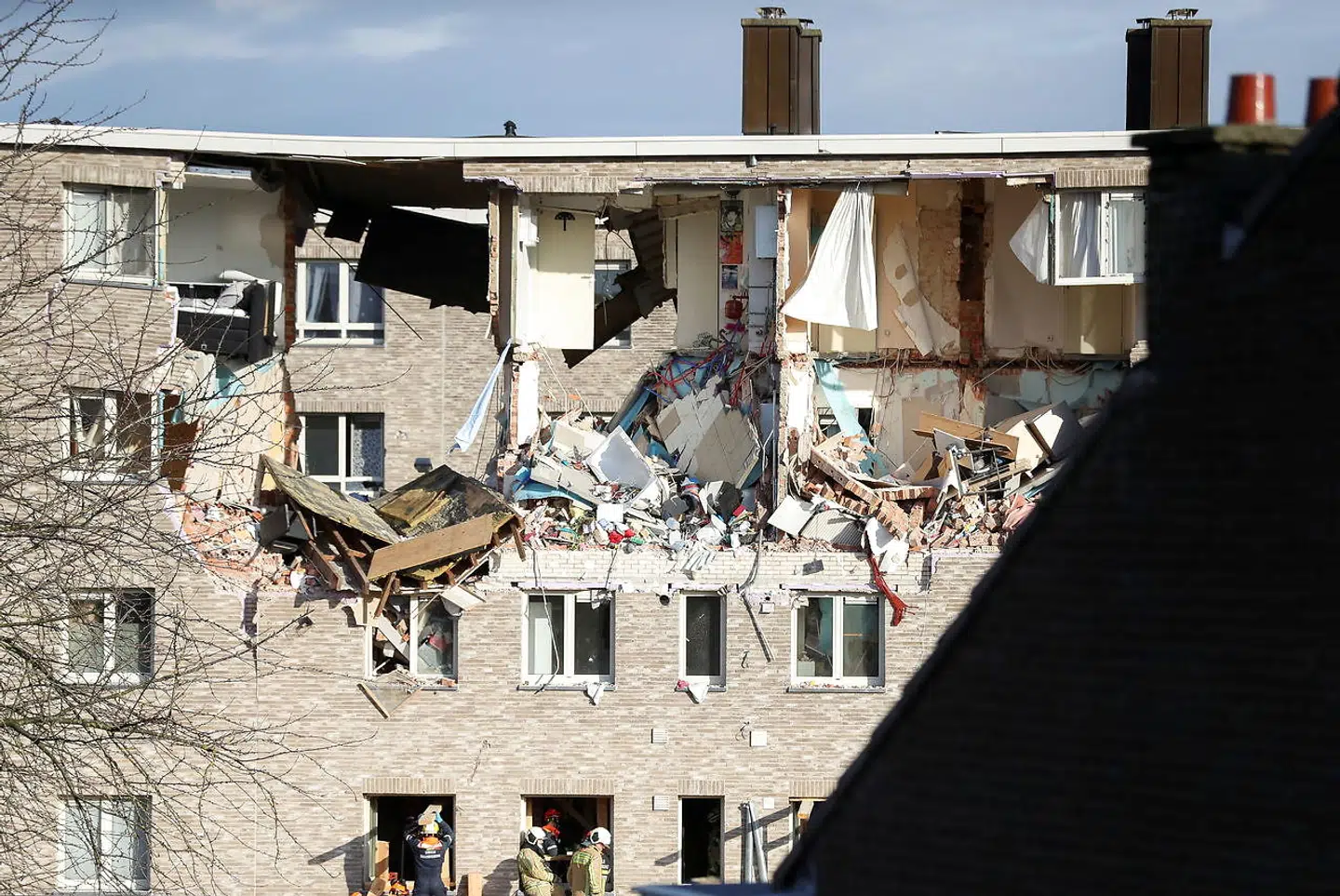 Rescue forces inspect the rubble of a building after an explosion in Turnhout, Belgium, December 31, 2021. REUTERS/Johanna Geron