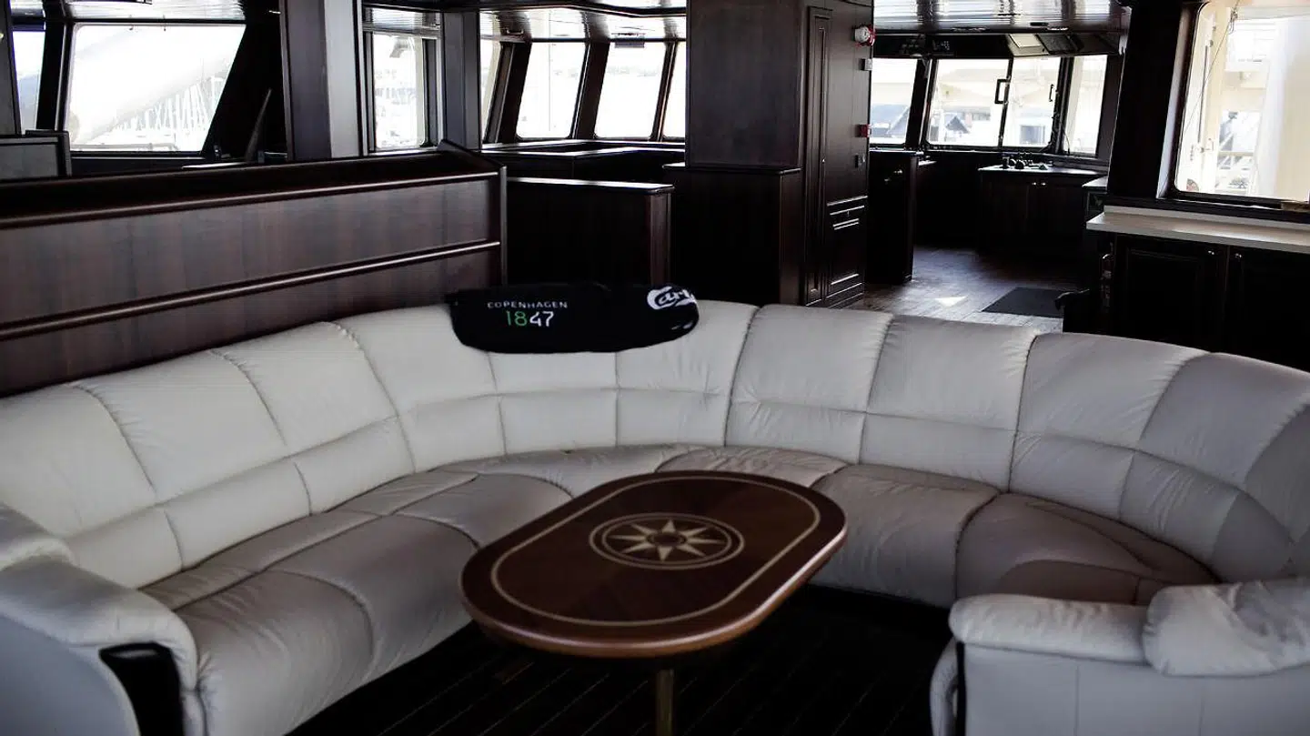 Sådan så loungeområdet ud. Alt er holdt meget stilrent i mørk mahogny og cremefarvet læder.