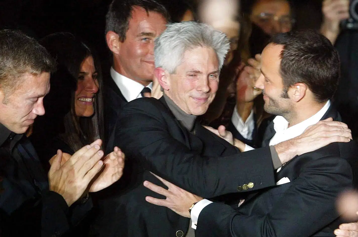 epa04159975 (FILE) A file picture dated 25 February 2004 shows US designer Tom Ford (R) embraced by his fiancee Richard Buckley (C) after he presented his Fall Winter 2004/05 collection for Italian fashion house Gucci during Milan Fashion Week in Milan, Italy. Ford revealed on 07 April 2014 that he has married Richard Buckley, his partner of 27 years, in USA. The couple welcomed a son named Alexander John Buckley Ford, born in September 2012. EPA/DANIEL DAL ZENNARO