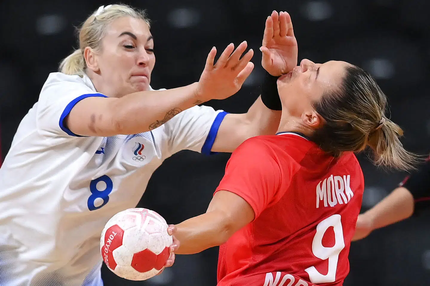 Russia's pivot Anna Sen (L) fouls Norway's right back Nora Moerk during the women's semifinal handball match between Norway and Russia of the Tokyo 2020 Olympic Games at the Yoyogi National Stadium in Tokyo on August 6, 2021. (Photo by Franck FIFE / AFP)