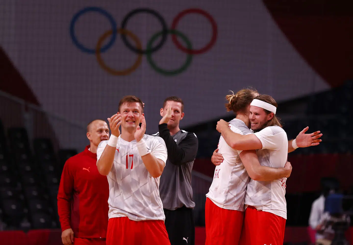 Tokyo 2020 Olympics - Handball - Men - Quarterfinal - Denmark v Norway - Yoyogi National Stadium - Tokyo, Japan - August 3, 2021. Lasse Svan of Denmark, Mikkel Hansen of Denmark and Henrik Moellgaard of Denmark celebrate after the match REUTERS/Susana Vera