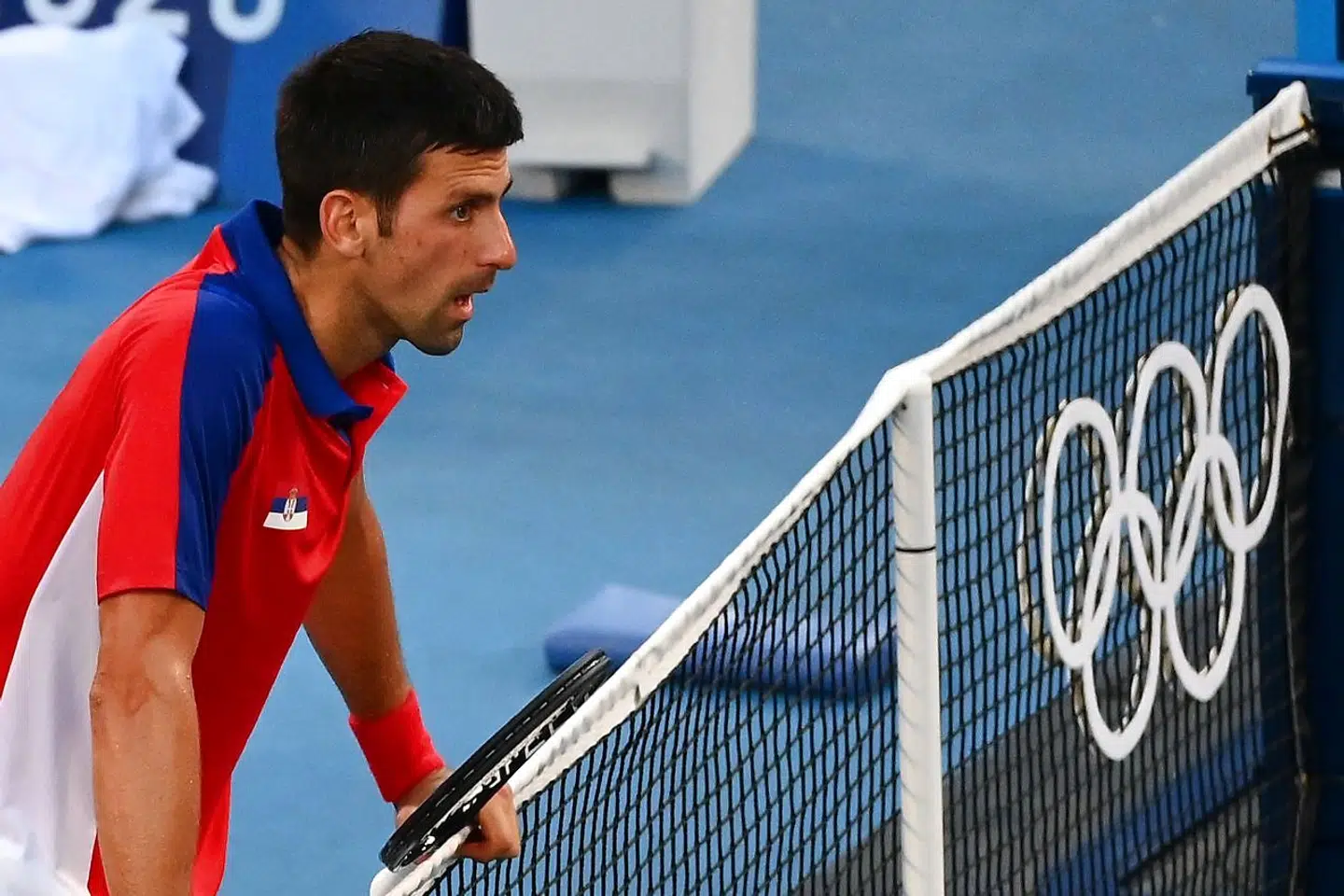 Serbia's Novak Djokovic reacts after losing to Spain's Pablo Carreno Busta their Tokyo 2020 Olympic Games men's singles tennis match for the bronze medal at the Ariake Tennis Park in Tokyo on July 31, 2021. (Photo by Vincenzo PINTO / AFP)