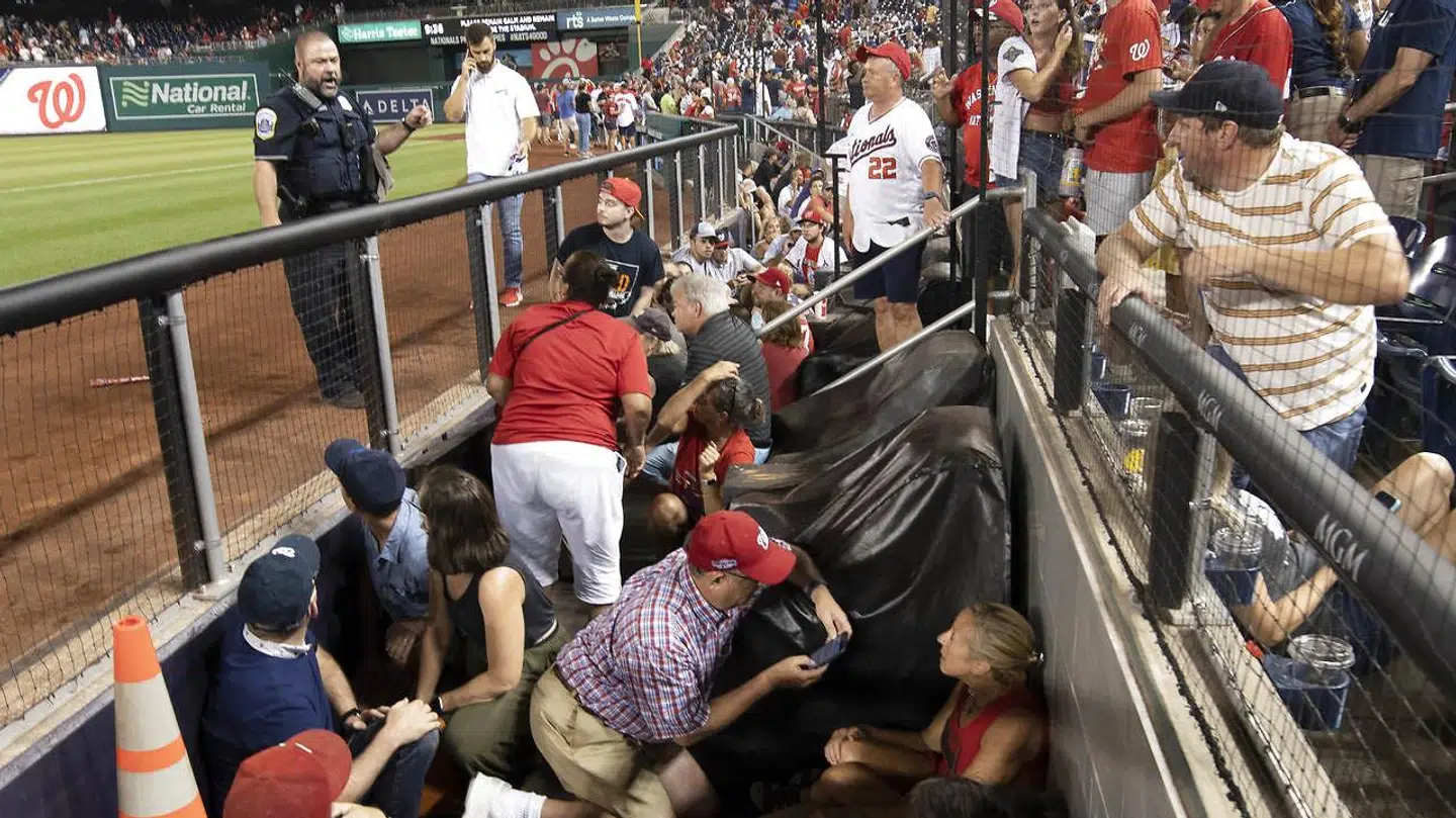 Paniske tilskuere forsøger at gemme sig.