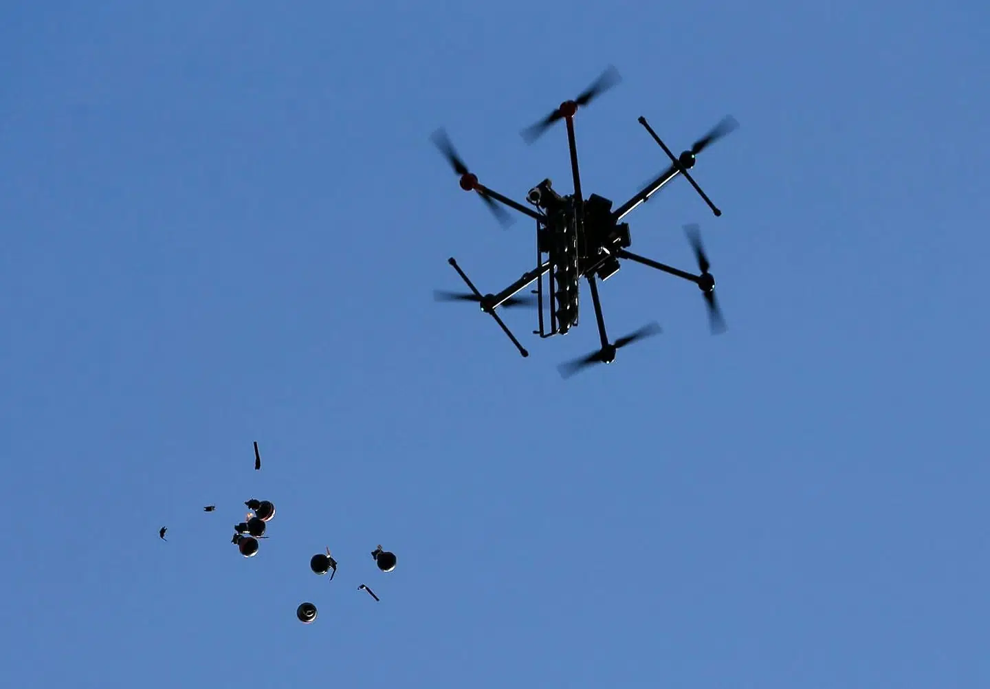An Israeli drone releases stun grenades on Palestinians demonstrating against the latest tensions in Jerusalem and the occupied West Bank as well as the bombing of the Gaza Strip by Israel, on May 16, 2021, near the settlement of Beit El not far from Ramallah. - Israeli strikes killed 42 Palestinians in the Gaza Strip today, the worst daily toll yet in almost a week of deadly clashes, as the UN Security Council met amid global alarm at the escalating conflict. (Photo by ABBAS MOMANI / AFP)