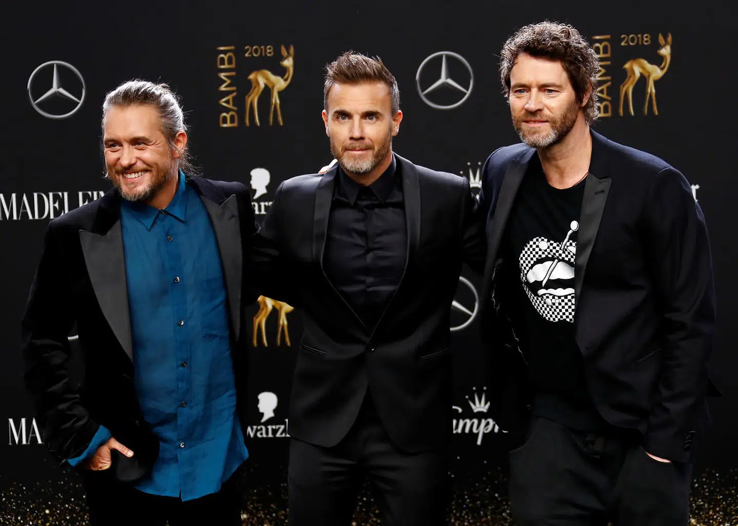 De tre tilbageværende 'Take That' medlemmer Howard Donald, Gary Barlow og Mark Owen håber, at de kan lokke Robbie Williams med på Tour. Her er de fra en koncert i 2018. Foto REUTERS/Fabrizio Bensch