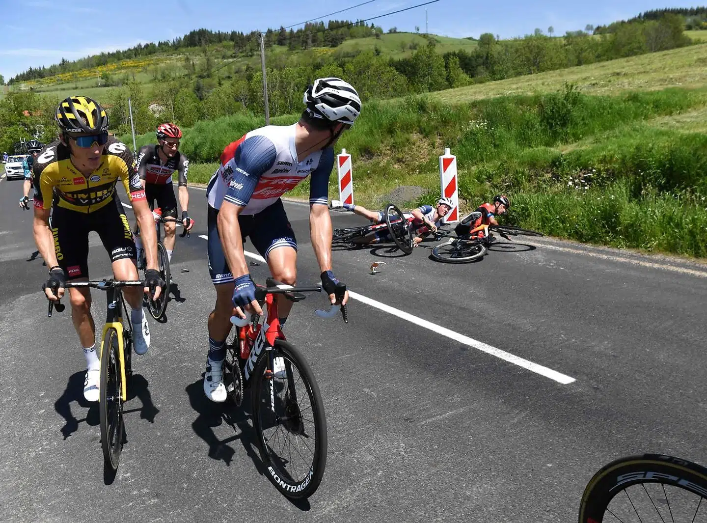 Team Bahrain's Santiago Buitrago of Colombia (R) and Team Trek's Mads Pedersen of Denmark are watched by other riders after crashing during the third stage of the 73rd edition of the Criterium du Dauphine cycling race, 172km between Langeac and Saint-Haon-Le-Vieux on June 1, 2021. (Photo by Alain JOCARD / AFP)