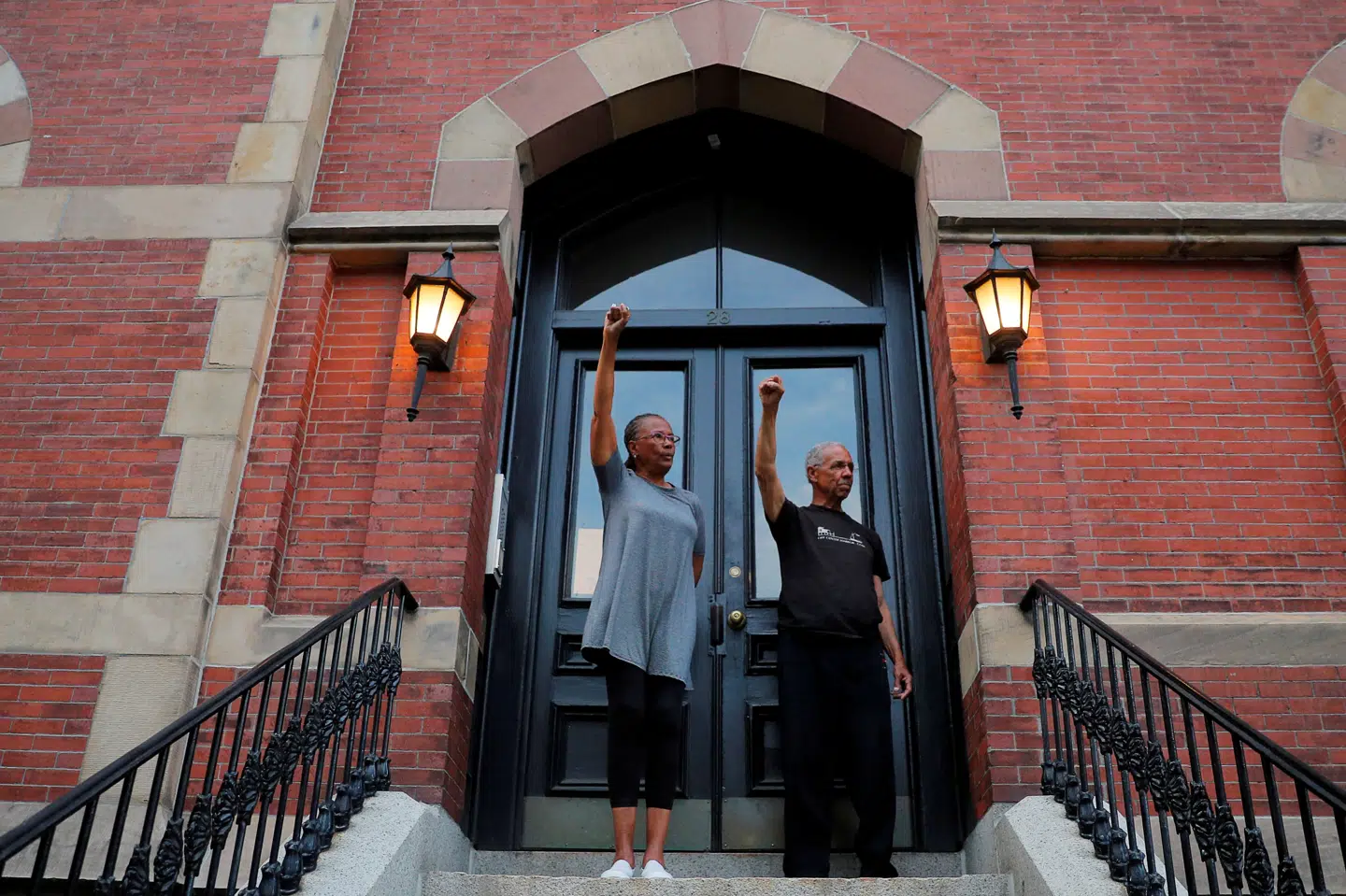 Bettye og Robert Freeman knytter fra deres trappesten i Boston i stilhed næverne i solidaritet med demonstranter, som gengælder gestussen. Brian Snyder/Reuters