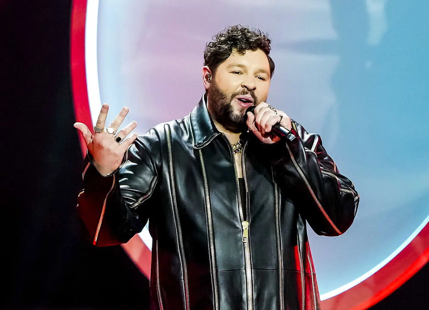 epa09221624 James Newman from the United Kingdom with the song 'Embers' performs during the Grand Final of the 65th annual Eurovision Song Contest (ESC) at the Rotterdam Ahoy arena, in Rotterdam, The Netherlands, 22 May 2021. Due to the coronavirus (COVID-19) pandemic, only a limited number of visitors is allowed at the 65th edition of the Eurovision Song Contest (ESC2021) that is taking place in an adapted form at the Rotterdam Ahoy. EPA/Sander Koning / POOL *** Local Caption *** 50359766