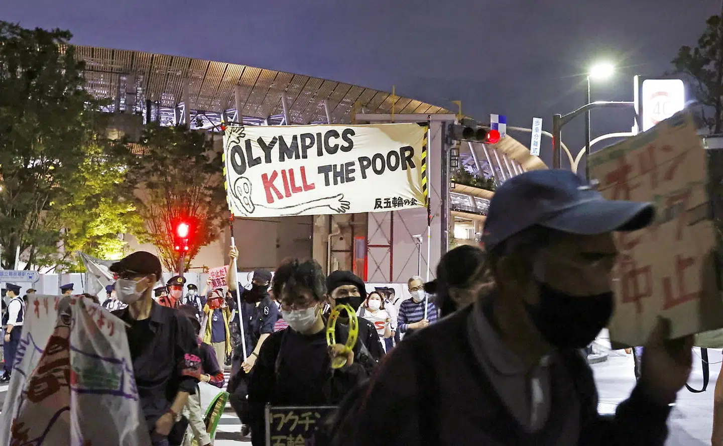 People protest against holding the Tokyo 2020 Olympics, amid the coronavirus disease (COVID-19) outbreak, around Olympic Stadium (National Stadium) as an Olympic test event for athletics is held inside the venue in Tokyo, Japan May 9, 2021, in this photo taken by Kyodo. Kyodo/via REUTERS ATTENTION EDITORS - THIS IMAGE WAS PROVIDED BY A THIRD PARTY. MANDATORY CREDIT. JAPAN OUT.NO COMMERCIAL OR EDITORIAL SALES IN JAPAN