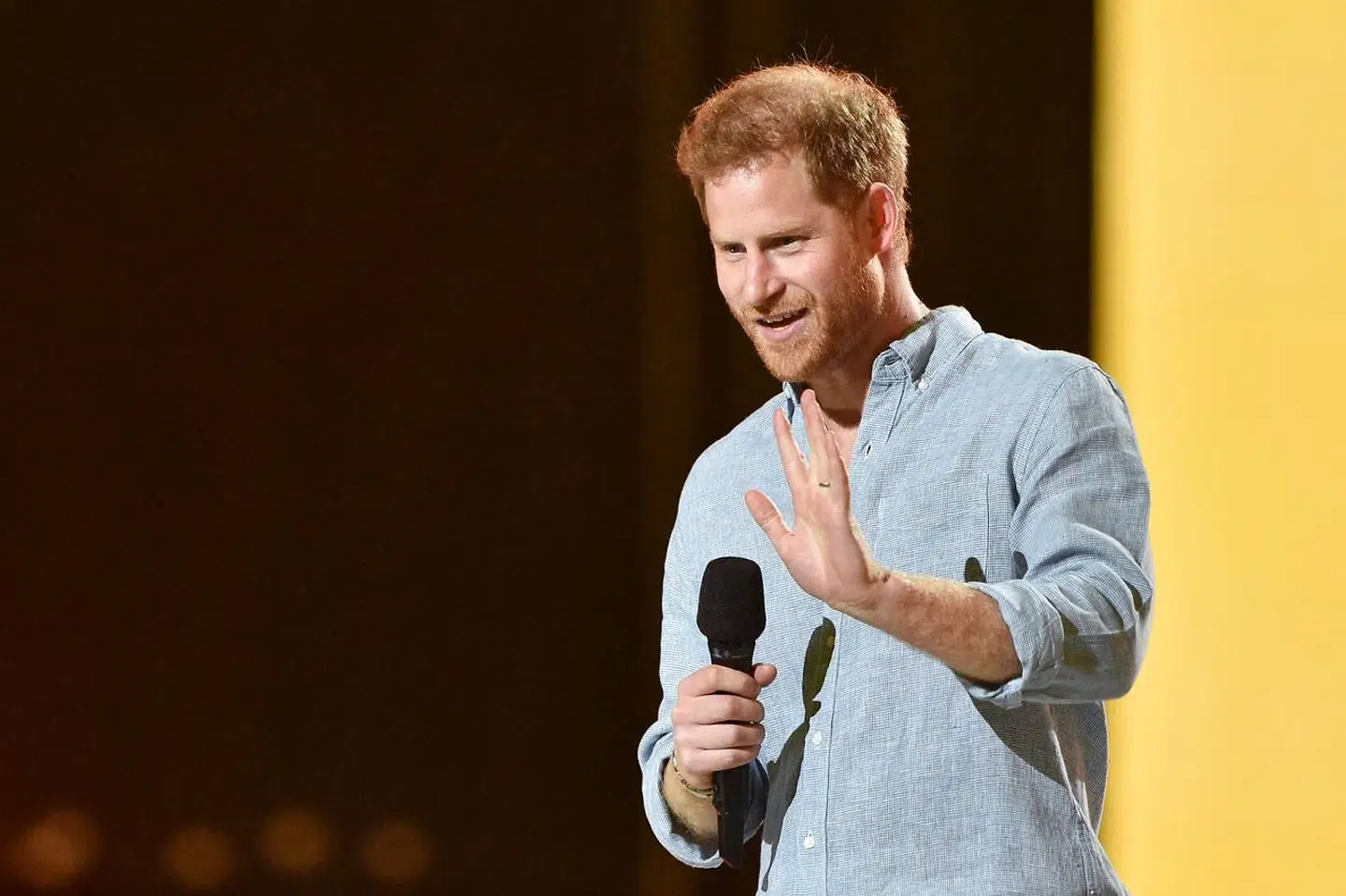 Co-Chair Britain's Prince Harry, Duke of Sussex, waves as he speaks onstage to speak during the taping of the "Vax Live" fundraising concert at SoFi Stadium in Inglewood, California, on May 2, 2021. - The fundraising concert "Vax Live: The Concert To Reunite The World", put on by international advocacy organization Global Citizen, is pushing businesses to "donate dollars for doses, " and for G7 governments to share excess vaccines. The concert will be pre-taped on May 2 in Los Angeles, and will stream on YouTube along with American television networks ABC and CBS on May 8. (Photo by VALERIE MACON / AFP)