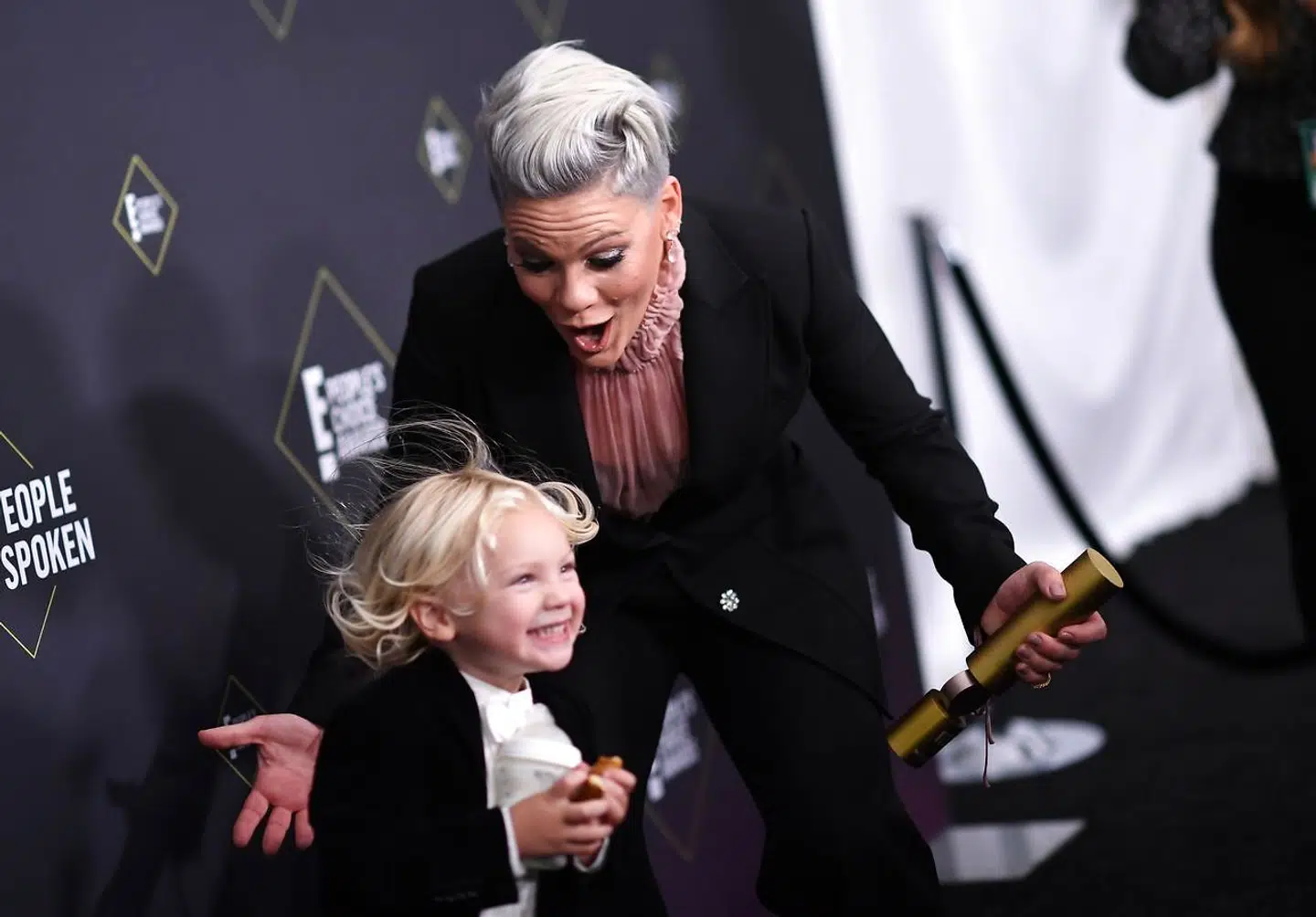 (FILES) In this file photo US singer/songwriter Pink reacts as her son Jameson Moon Hart runs towards her as she gets ready to pose with the People's Champion Award during the 45th annual E! People's Choice Awards at Barker Hangar in Santa Monica, California, on November 10, 2019. - On April 3, singer Pink announced on twitter that she and her son showed symptoms of Covid-19 2 weeks ago. She tested positive. They both were re-tested and are now negative. She donated half a million dollars to Temple University Hospital Emergency Hospital in Philadelphia (where her mom worked for 18 years) and another half million to the City Of Los Angeles Maypr's Emergency Covid-19 Crisis Fund. (Photo by VALERIE MACON / AFP)