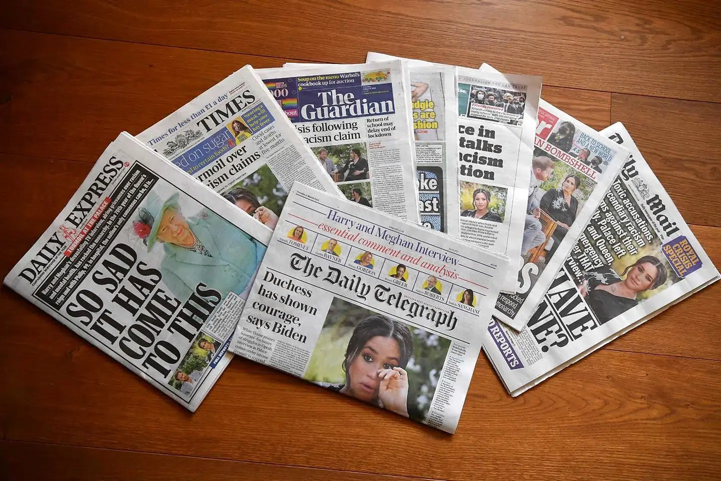 An arrangement of UK daily newspapers photographed as an illustration in Brenchley, Kent on March 9, 2021, shows front page headlines reporting on the story of the interview given by Meghan, Duchess of Sussex, wife of Britain's Prince Harry, Duke of Sussex, to Oprah Winfrey, which aired on UK broadcaster ITV. - Britain's Queen Elizabeth was in crisis talks on March 9, 2021, after Prince Harry and his wife Meghan lifted the lid on life inside Buckingham Palace with an explosive interview that reverberated around the world, local media reported. (Photo by Ben STANSALL / AFP)