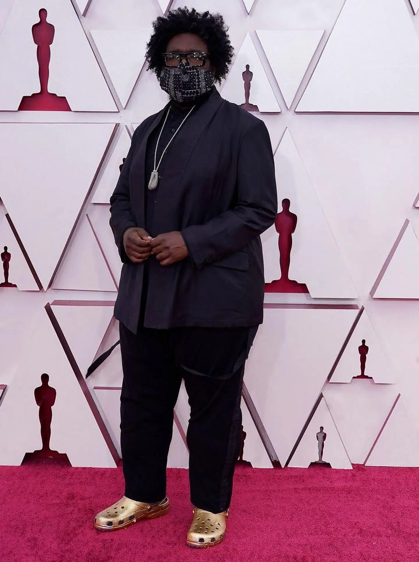 Instruktøren Questlove har iført sig et par af de famøse Crocs-sko - dog i guld - til festen.