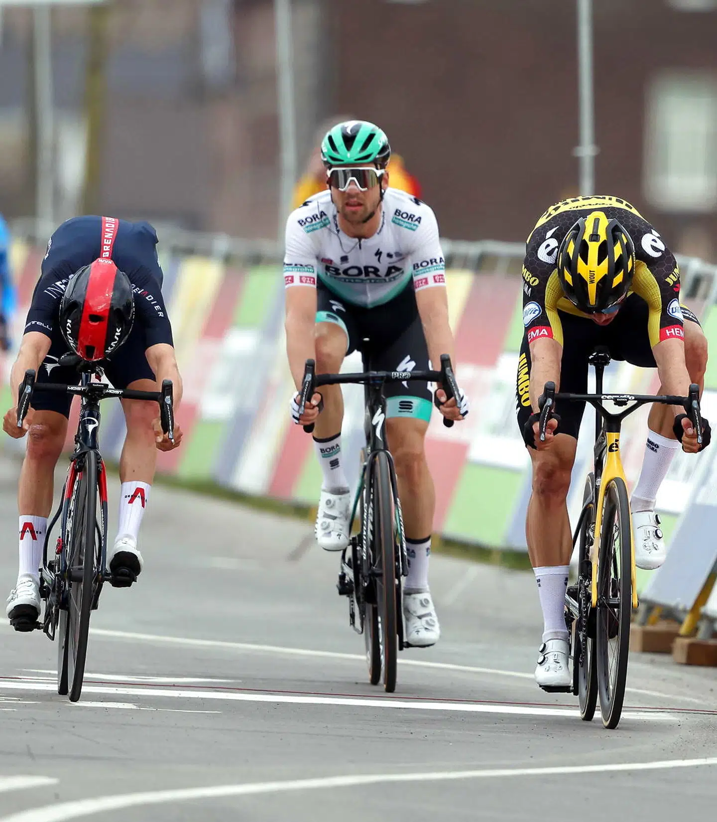 epa09143724 Belgian rider Wout Van Aert (R) of Team Jumbo-Visma crosses the finish line to win the Amstel Gold Race over 218.6km in Valkenburg, Netherlands, 18 April 2021. Van Aert won ahead of second placed British rider Thomas Pidcock (L) of the Ineos Grenadiers team and third placed German rider Maximilian Schachmann (C) of the Bora - Hansgrohe team. EPA/Marcel Van Hoorn