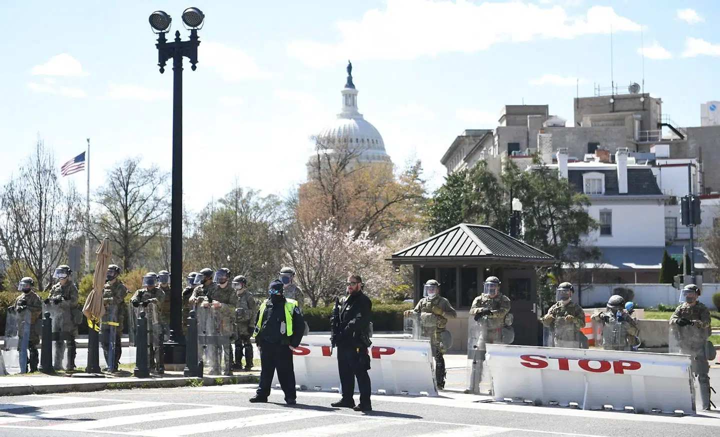 TOPSHOT - Police and members of the National Guard block a street near the US Capitol on April 2, 2021, after a vehicle drove into US Capitol police officers in Washington, DC. - Two police officers were injured near the US Capitol on Friday after being rammed by a vehicle whose driver was subsequently arrested, police said. "A suspect is in custody. Both officers are injured. All three have been transported to the hospital, " the US Capitol Police department said on Twitter. (Photo by Eric BARADAT / AFP)