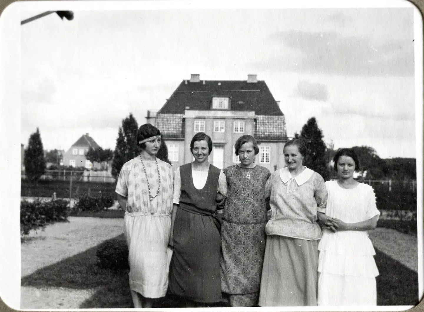 Her ses huset på et privatfoto fra 1924. Kvinderne i familien overfor stiller op til foto, og i baggrunden ses Det Hvide Hus, som på dette tidspunkt var gult.