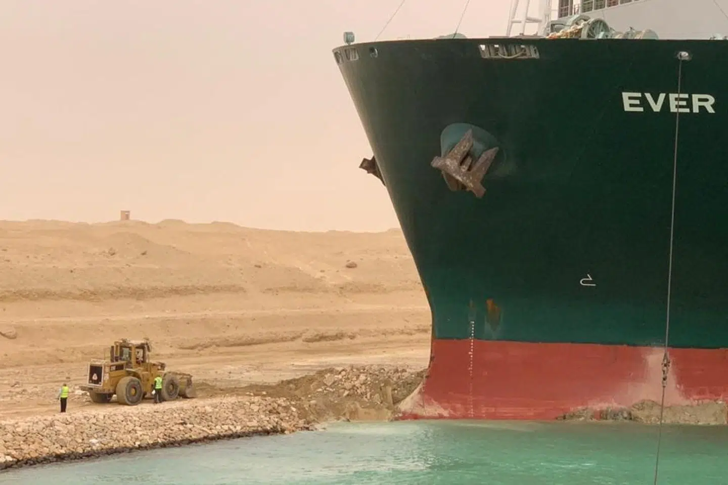 Det var formentlig kraftig vind, der fik et gigantisk containerskib til at lægge sig på tværs af den trafikerede Suezkanal i Egypten. Handout/Reuters