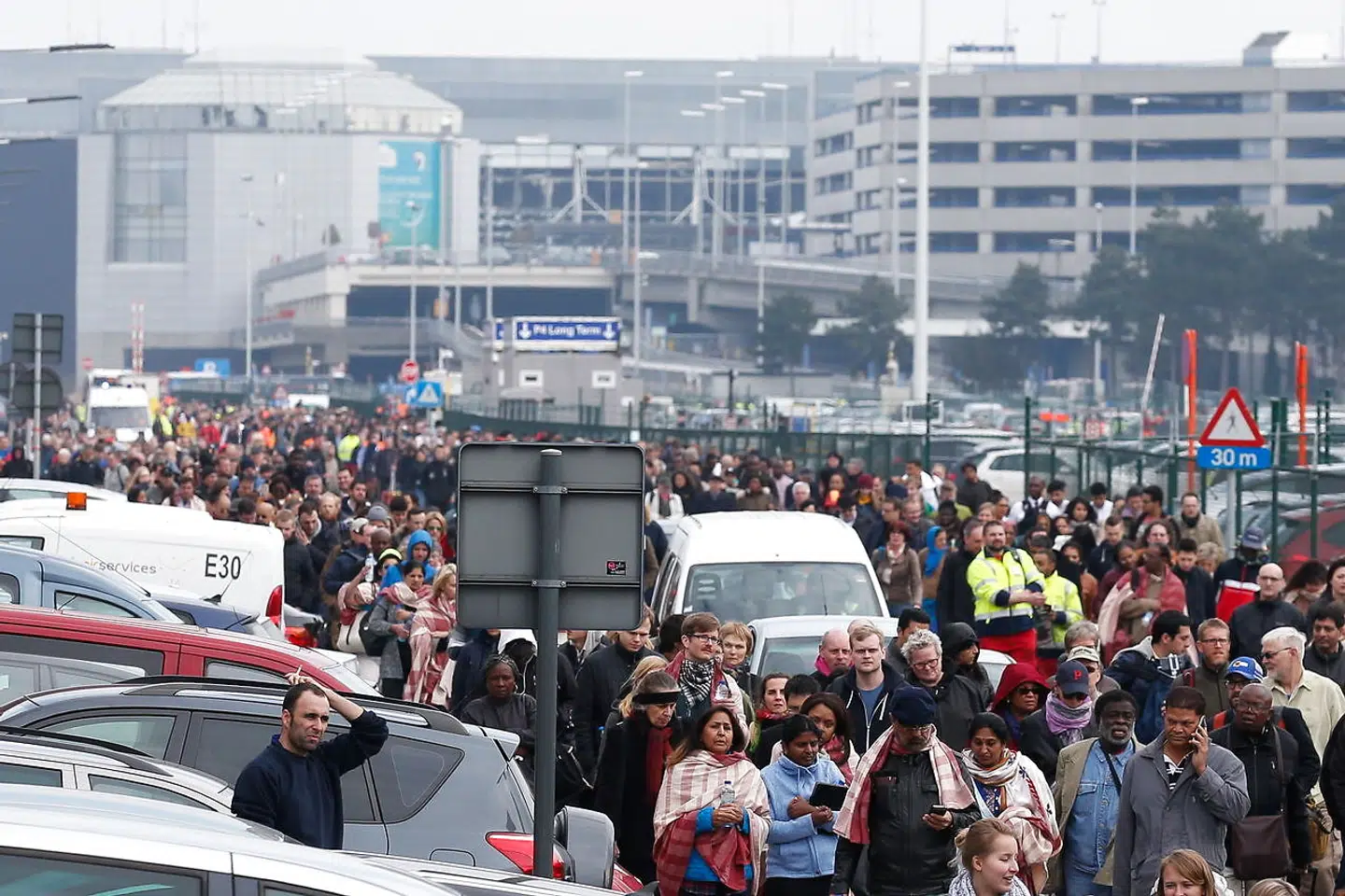 epa09088321 (FILE) - Passengers and airport staff are evacuated from the terminal building after explosions at Brussels Airport in Zaventem near Brussels, Belgium, 22 March 2016 (reissued 21 March 2021). A total of 31 people were killed and hundreds others injured in terrorist attacks on the Brussel Airport and on the Maalbeek Metro station for which the so-called 'Islamic State' (IS) later had claimed responsibility. EPA/LAURENT DUBRULE *** Local Caption *** 52662888