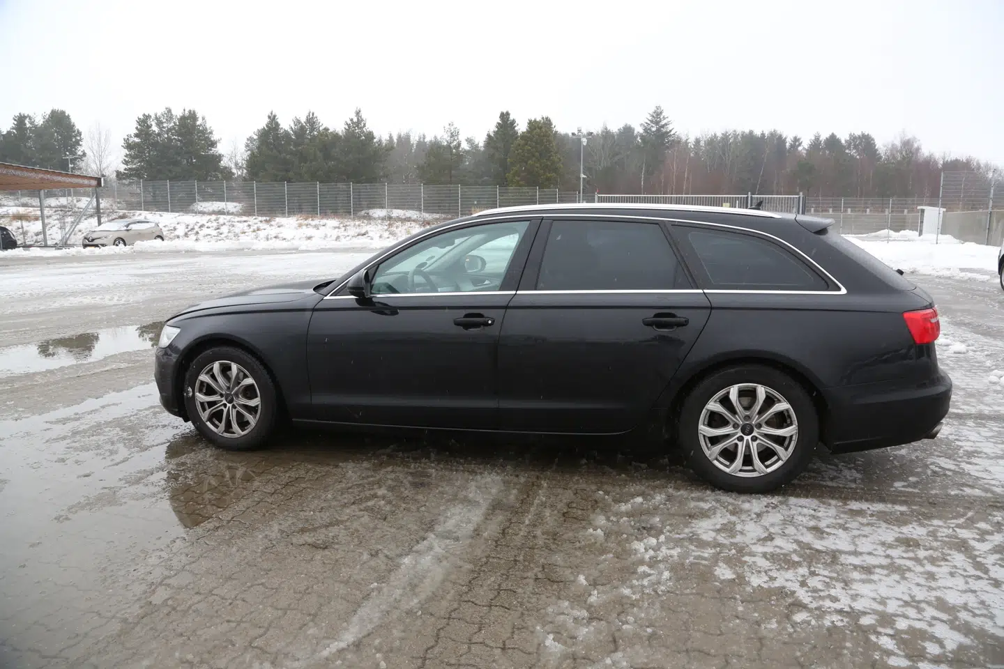 Denne sorte Audi A6 stationcar blev ifølge politiet brugt af morderne som flugtbil. Den er nu ved at blive gransket af politiets teknikere for mikroskopiske spor af gerningsmændene.