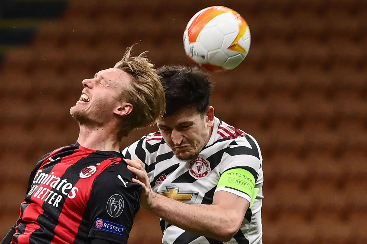 AC Milan's Danish defender Simon Kjaer (L) and Manchester United's England's defender Harry Maguire go for a header during the UEFA Europa League round of 16 second leg football match between AC Milan and Manchester United at San Siro stadium in Milan on March 18, 2021. (Photo by Marco BERTORELLO / AFP)