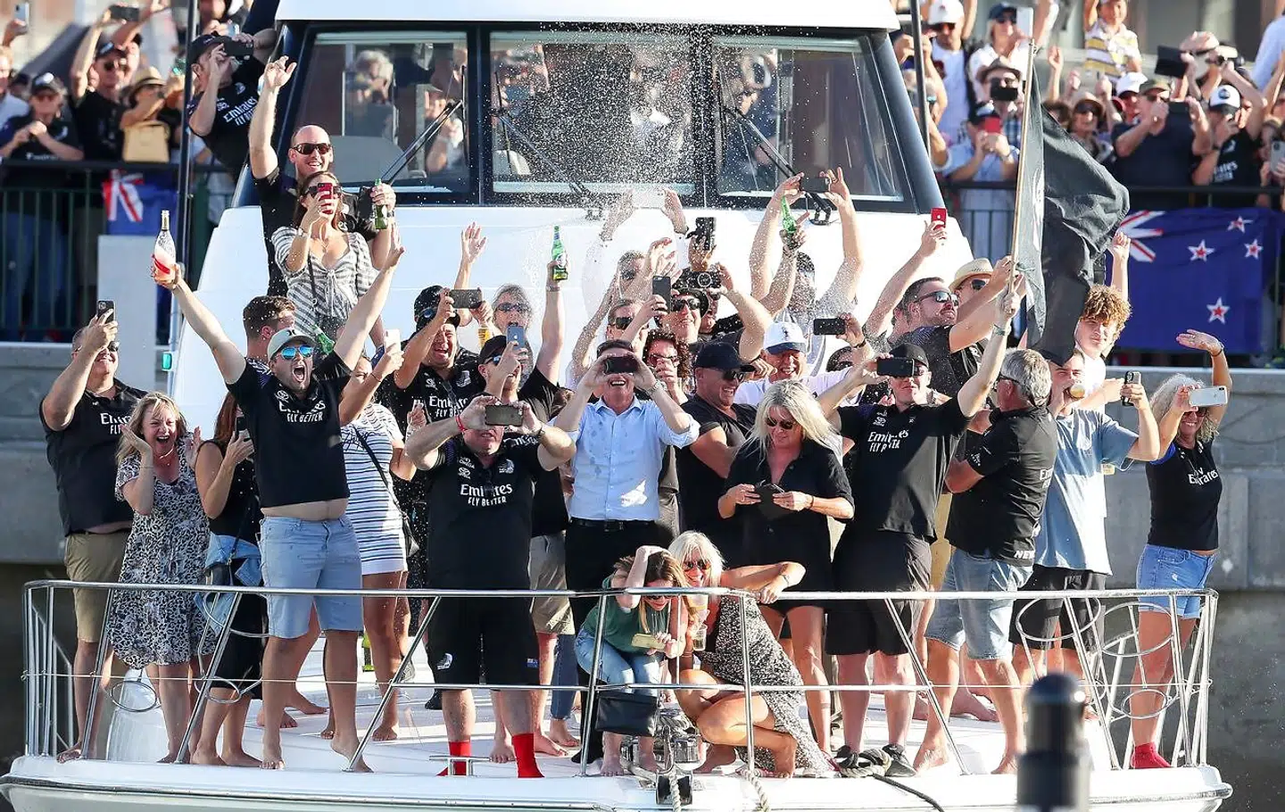 Sailing - 36th America's Cup - Waitemata Harbour, Auckland, New Zealand - March 17, 2021 Fans celebrate after Emirates Team New Zealand won the 36th America's Cup REUTERS/Simon Watts