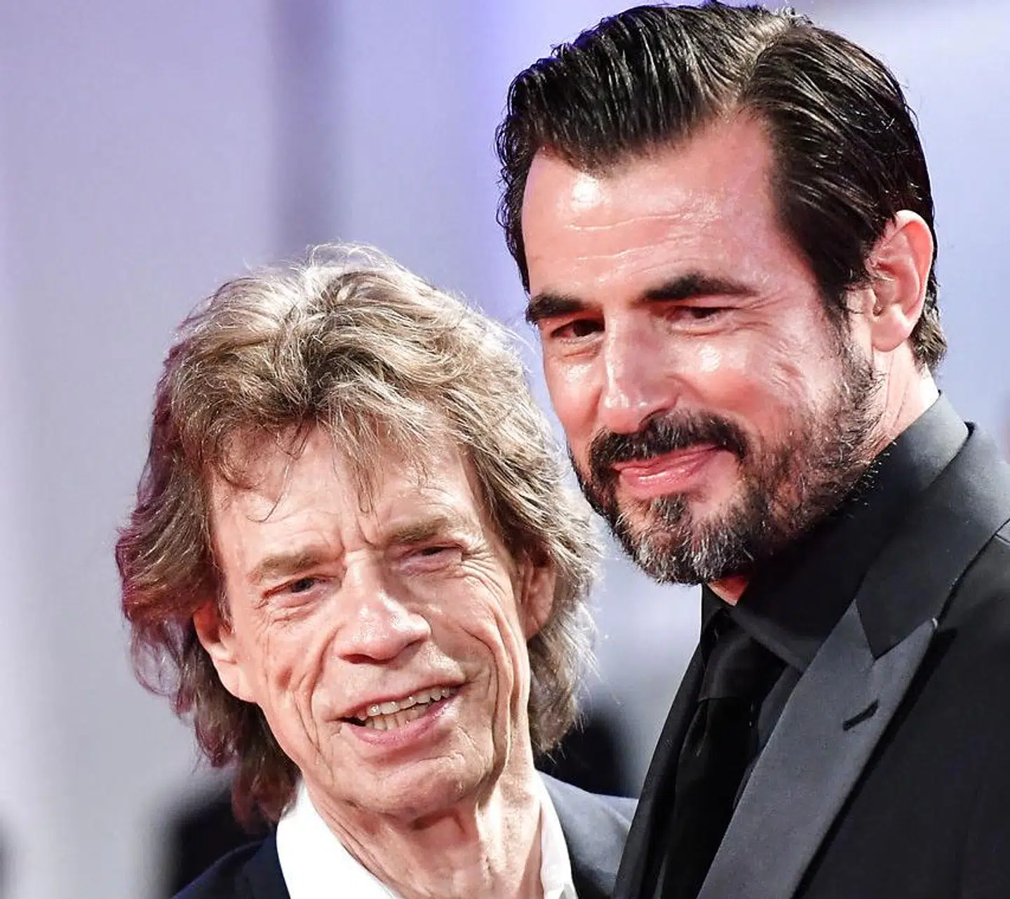 English singer, songwriter and actor Mick Jagger (L) and Danish actor Claes Bang arrive for the screening of the film "The Burnt Orange Heresy" during the closing night of the 76th Venice Film Festival on September 7, 2019 at Venice Lido. Alberto PIZZOLI / AFP