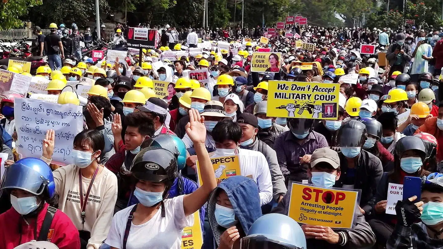 Protesters wearing hard hats and helmets display placards as they rally against the military coup in the northern town of Myitkyina, the capital of Kachin state, Myanmar February 20, 2021, in this picture obtained by Reuters. PHOTO OBTAINED BY REUTERS/via REUTERS THIS IMAGE HAS BEEN SUPPLIED BY A THIRD PARTY.NO RESALES.NO ARCHIVES.