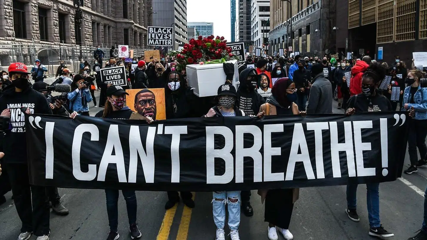 Demonstrators hold placards during the "I Can't Breathe - Silent March for Justice" in front of the Hennepin County Government Center on March 7, 2021, where the trial of former Minneapolis police officer Derek Chauvin, charged with murdering African American man George Floyd, will begin on March 8, 2021, in Minneapolis, Minnesota.