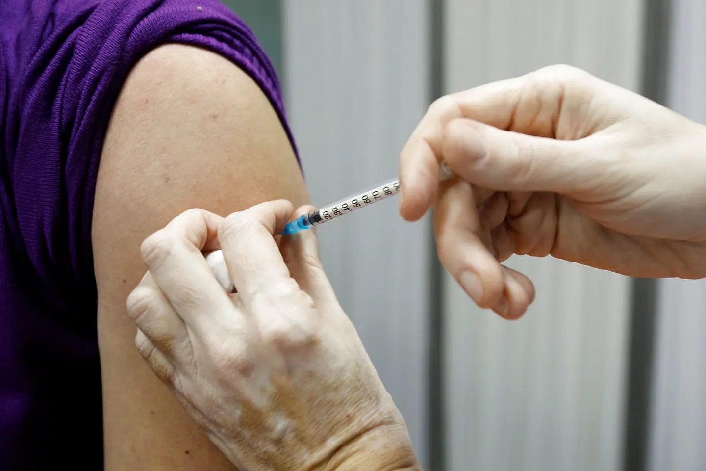 FILE PHOTO: A healthcare worker administers a dose of the Sputnik V coronavirus disease (COVID-19) vaccine to her colleague in Podgorica, Montenegro, February 22, 2021. REUTERS/Stevo Vasiljevic/File Photo