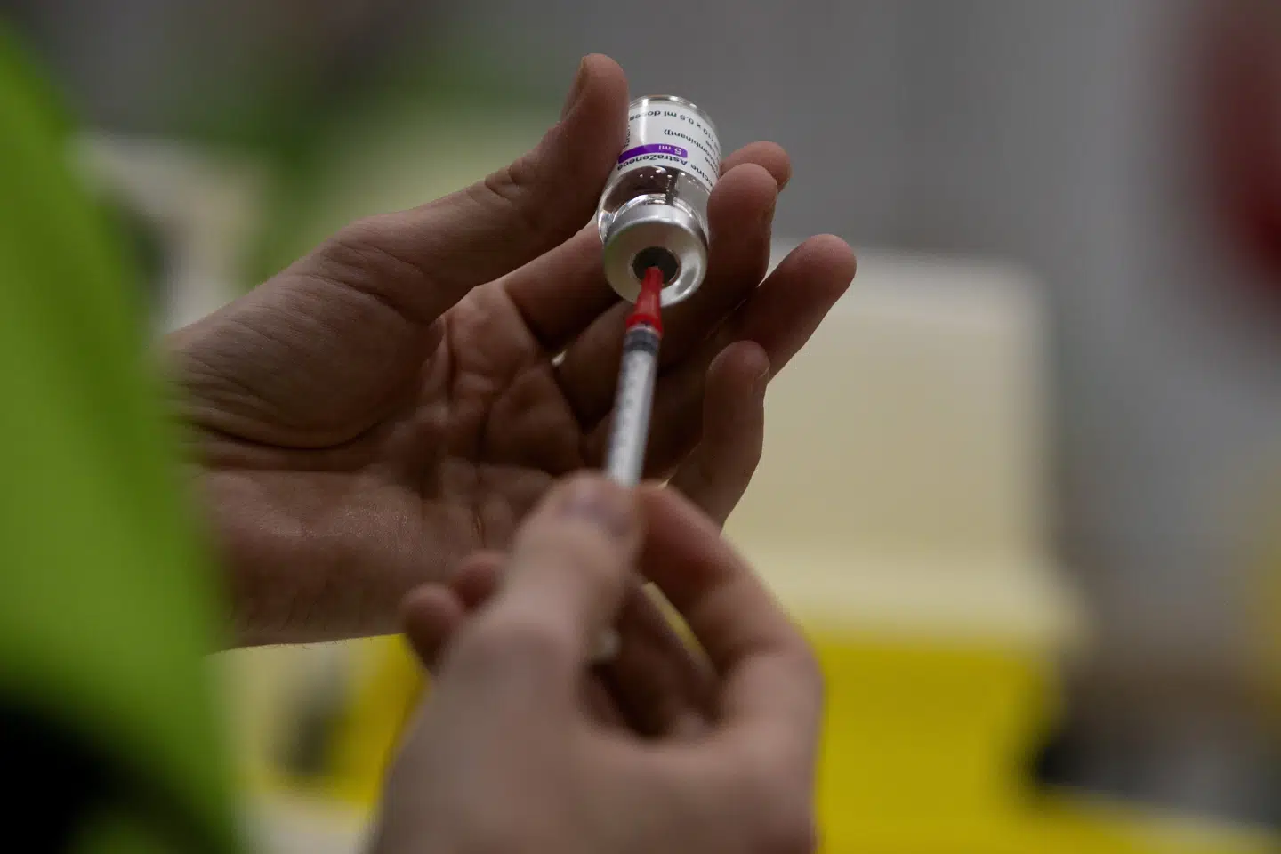 A pharmacist fills a syringe from a vial of the AstraZeneca coronavirus vaccine at the Vaccine Village in Antwerp, Belgium, on Friday, Feb. 19, 2021. (AP Photo/Virginia Mayo) Virginia Mayo/Ritzau Scanpix