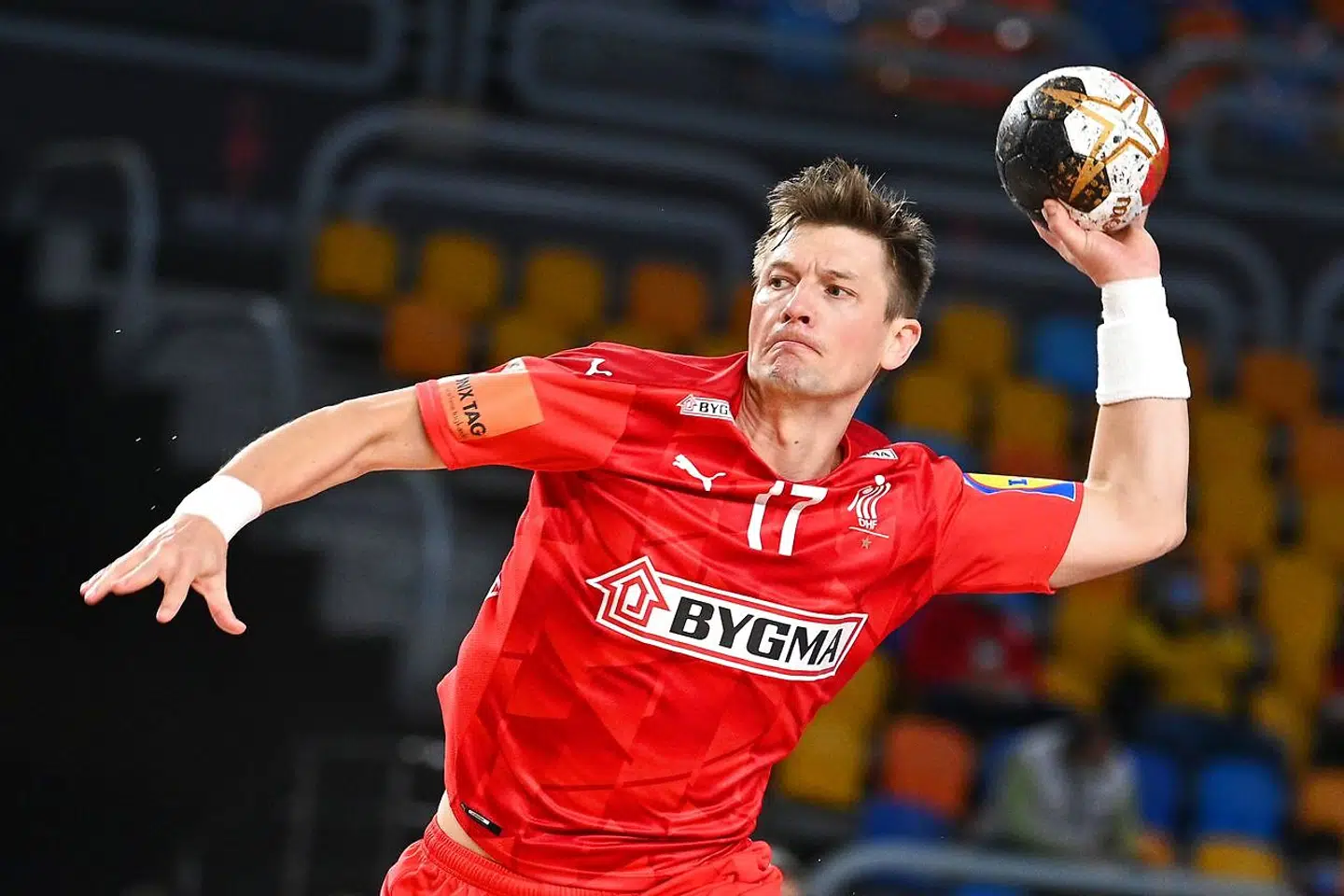 Denmark's right winger Lasse Svan jumps to shoot during the 2021 World Men's Handball Championship between Group II teams Denmark and Qatar at the Cairo Stadium Sports Hall in the Egyptian capital on January 21, 2021. (Photo by Anne-Christine POUJOULAT / POOL / AFP)