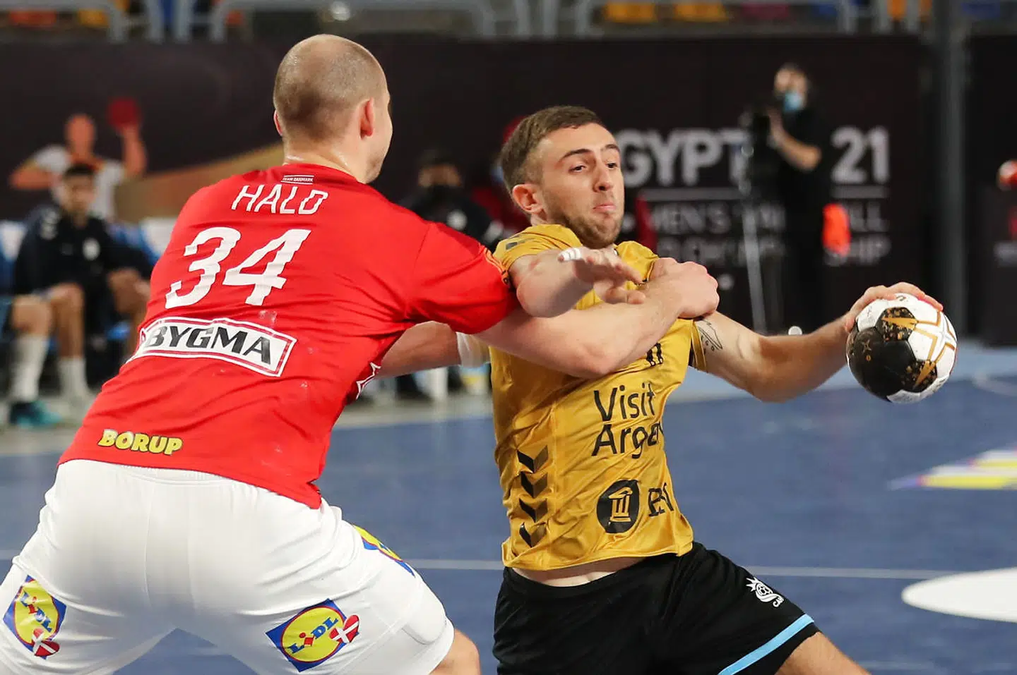Handball - 2021 IHF Handball World Championship - Preliminary Round Group D - Denmark v Argentina - Cairo Stadium Hall 1, Cairo, Egypt - January 19, 2021 Argentina's Manuel Crivelli in action with Denmark's Simon Hald Jensen REUTERS/Mohamed Abd El Ghany