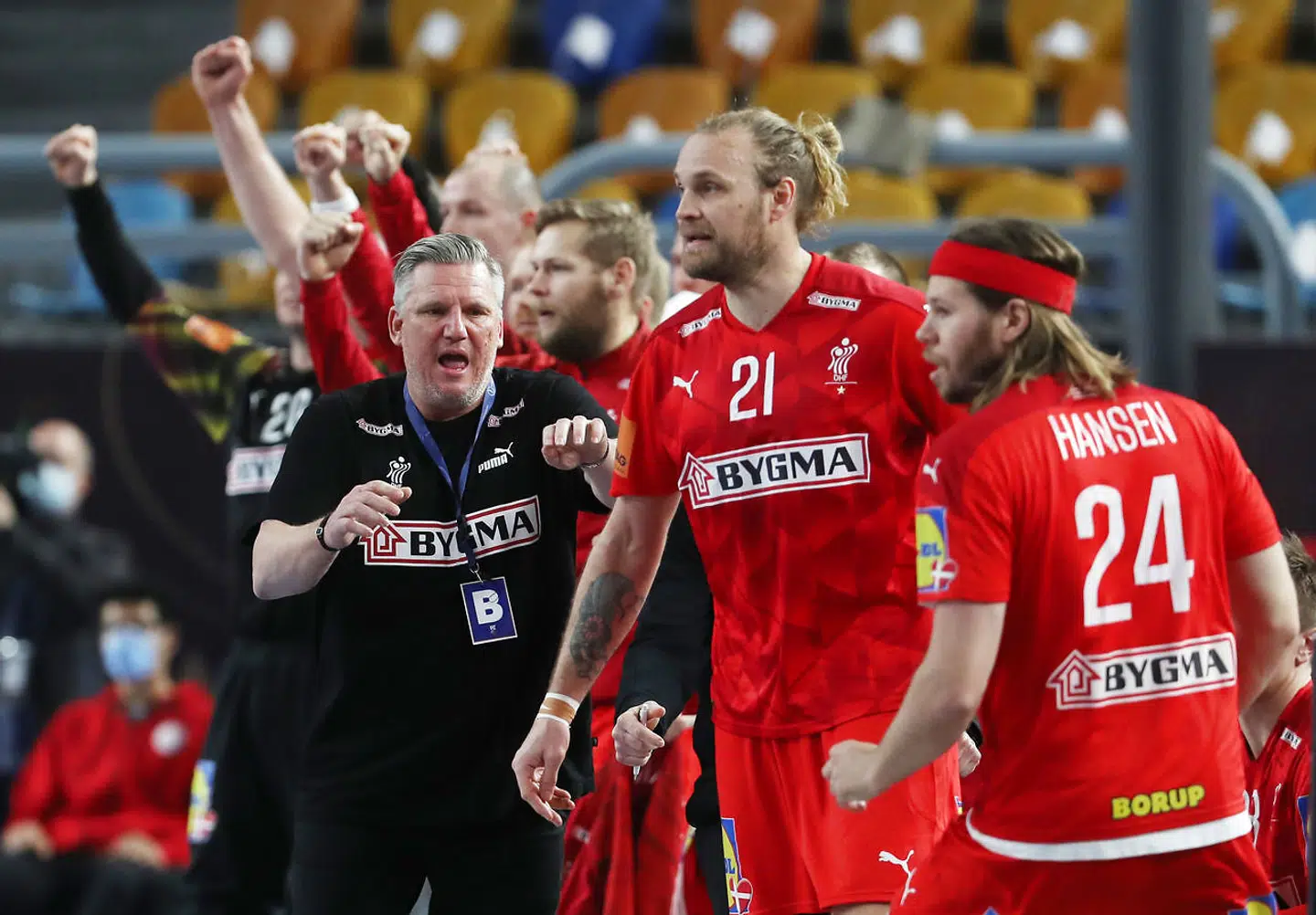 Handball - 2021 IHF Handball World Championship - Main Round Group 2 - Denmark v Qatar - Cairo Stadium Hall 1, Cairo, Egypt - January 21, 2021 Denmark head coach Nikolaj Bredahl Jacobsen with Mikkel Hansen and teammates Pool via REUTERS/Mohamed Abd El Ghany