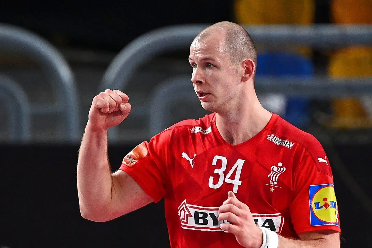Denmark's pivot Simon Hald Jensen celebrates after scoring during the 2021 World Men's Handball Championship between Group II teams Denmark and Qatar at the Cairo Stadium Sports Hall in the Egyptian capital on January 21, 2021. (Photo by Anne-Christine POUJOULAT / POOL / AFP)