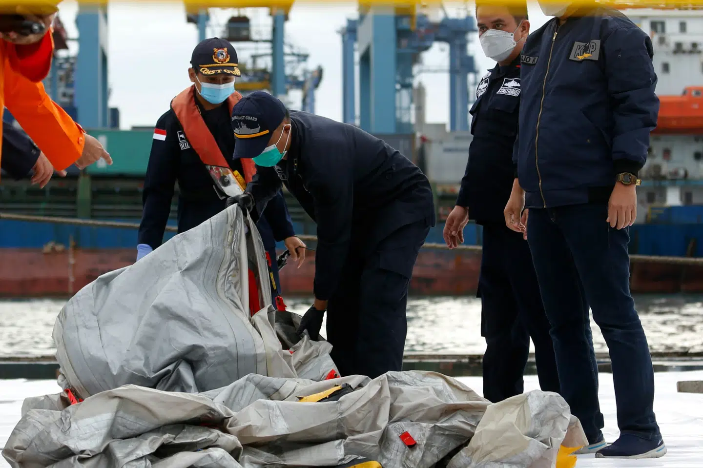 Indonesiske redningsfolk bærer det, der menes at være resterne af et Sriwijaya Air-fly, der styrtede ned i havet ud for Jakarta lørdag. Ajeng Dinar Ulfiana/Reuters