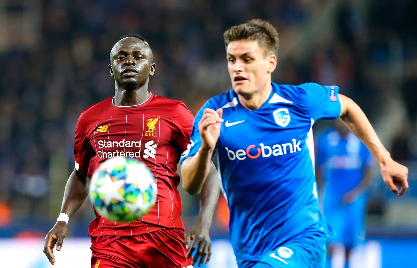 Liverpool's Senegalese striker Sadio Mane (L) eyes the ball as he vies for it with RC Genk's Danish defender Joakim Maehle (R) during the UEFA Champions League Group E football match between (KRC) Genk and Liverpool on October 23, 2019 at the Luminus Arena in Genk.  François WALSCHAERTS / AFP