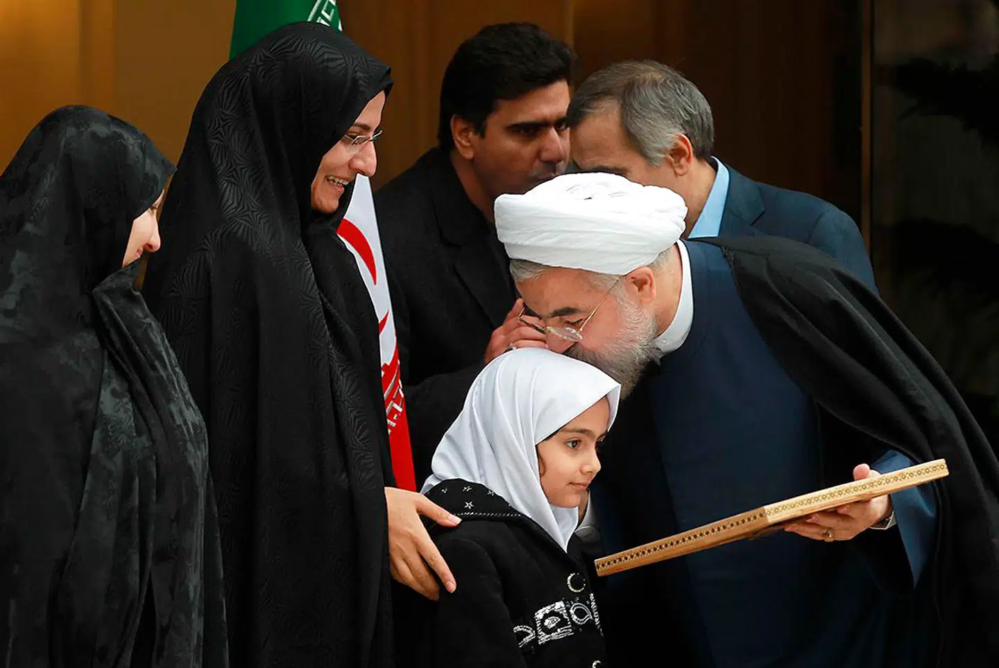 Præsident i den islamiske republik Hassan Rouhani, ses her omfavne familien til dræbte Darioush Rezaeinejad. Arkivfoto