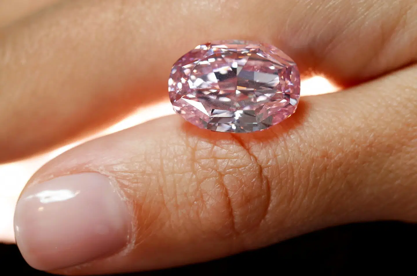 A model poses with "The Spirit of the Rose", the world's largest vivid purple-pink diamond with 14.83-carat, before an upcoming Geneva auction on November 11 where it could fetch up to $38 million, during a Sotheby's preview in Geneva, Switzerland, November 6, 2020. REUTERS/Denis Balibouse