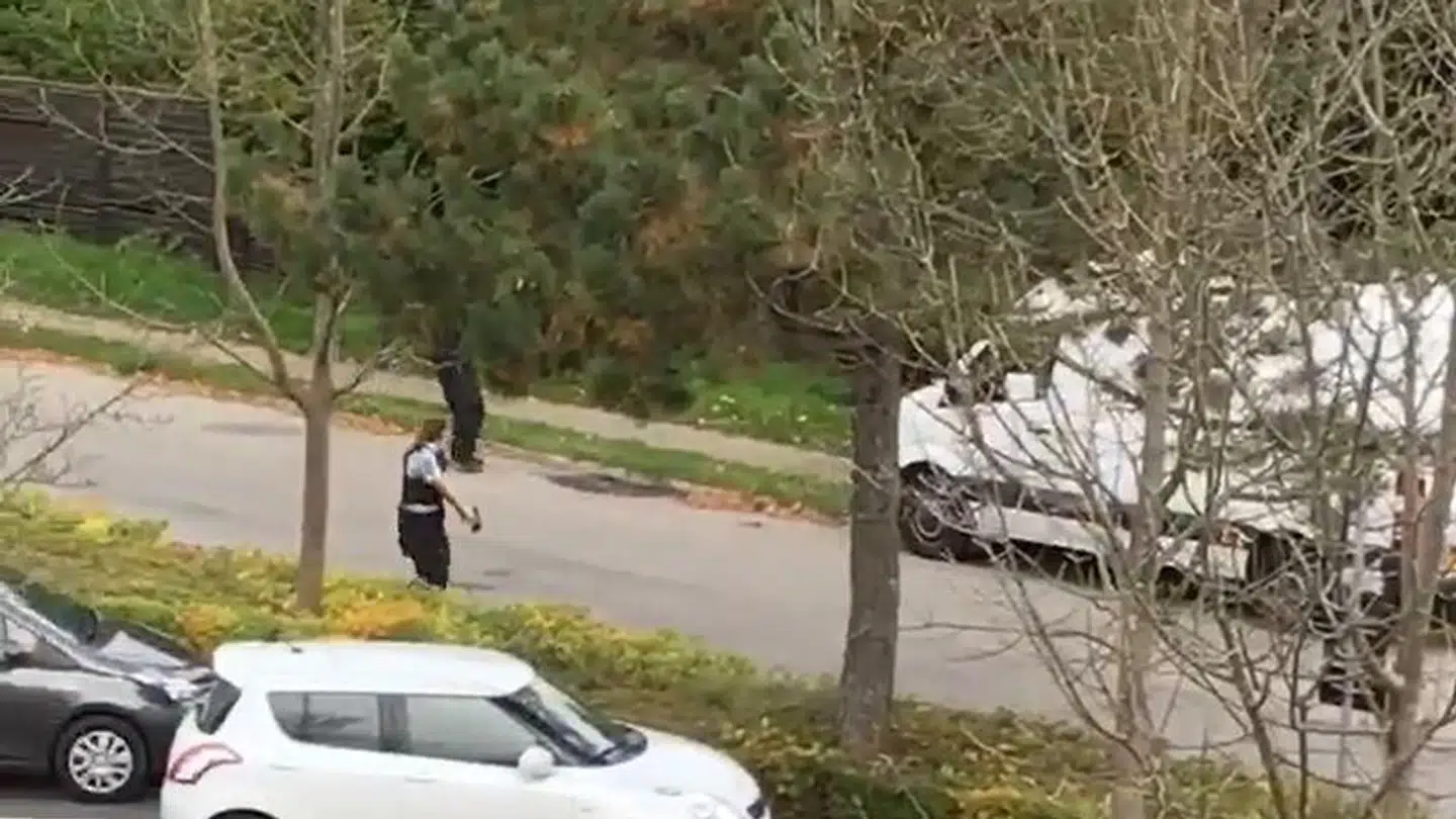 Betjente med våben hævet nærmer sig varvognen med Peter Madsen i.